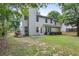 A view of backyard featuring a well-maintained lawn and a beige house at 2683 Berry Ridge Ct, Buford, GA 30519