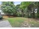 Backyard features lush trees with a stone pathway leading toward a backyard at 2683 Berry Ridge Ct, Buford, GA 30519