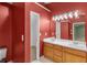 Bathroom featuring dual vanities, light wood cabinetry, and a large mirror with Hollywood-style lighting at 2683 Berry Ridge Ct, Buford, GA 30519