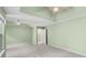 Light and airy bedroom with neutral carpet and a tray ceiling with dual ceiling fans at 2683 Berry Ridge Ct, Buford, GA 30519