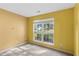 Sunlit bedroom with neutral carpet and a large window overlooking the neighborhood at 2683 Berry Ridge Ct, Buford, GA 30519