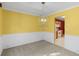 Dining room with modern chandelier, wainscoting, and a peek into the updated kitchen at 2683 Berry Ridge Ct, Buford, GA 30519