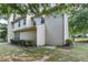 Exterior view featuring a beige home surrounded by green grass and manicured shrubs at 2683 Berry Ridge Ct, Buford, GA 30519