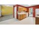 Functional kitchen with bright lighting, wooden cabinets, white appliances, and an adjacent living space at 2683 Berry Ridge Ct, Buford, GA 30519