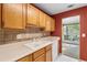 Bright kitchen features well-maintained countertops, wooden cabinets, and a convenient dishwasher at 2683 Berry Ridge Ct, Buford, GA 30519