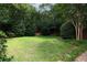 Lush backyard area with a green lawn, mature trees, and attractive landscaping at 2283 Falmouth Se Ct # 22, Smyrna, GA 30080