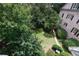 View of green lawn in backyard area with mature trees providing lots of shade to the outdoor space at 2283 Falmouth Se Ct # 22, Smyrna, GA 30080