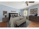 Serene bedroom features soft blue walls, hardwood floors, and a comfortable seating area at 2283 Falmouth Se Ct # 22, Smyrna, GA 30080