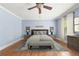Bright, serene bedroom with blue walls, hardwood floors, and a comfortable seating bench at 2283 Falmouth Se Ct # 22, Smyrna, GA 30080