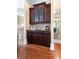 Charming butler's pantry featuring dark wood cabinets, granite counters, and a convenient wet bar at 2283 Falmouth Se Ct # 22, Smyrna, GA 30080