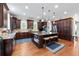 Spacious kitchen boasts dark wood cabinetry, granite countertops, and a large central island with seating at 2283 Falmouth Se Ct # 22, Smyrna, GA 30080