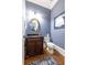 Stylish powder room with custom vanity, granite countertop, decorative mirror, and elegant fixtures at 2283 Falmouth Se Ct # 22, Smyrna, GA 30080
