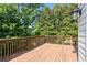 Spacious back deck with wood railings, surrounded by lush trees, offering privacy at 3053 Ramsey Pl, Marietta, GA 30062