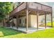 View of the backyard and elevated deck that shelters a concrete patio with door to the basement at 3053 Ramsey Pl, Marietta, GA 30062