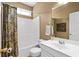Bright bathroom featuring a shower-tub combo with a decorative shower curtain and white vanity at 3053 Ramsey Pl, Marietta, GA 30062