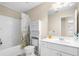 Bright bathroom featuring a shower-tub combo with a floral shower curtain and white vanity at 3053 Ramsey Pl, Marietta, GA 30062