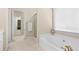 Bathroom showcasing a large bathtub, walk-in shower, and gold fixtures at 3053 Ramsey Pl, Marietta, GA 30062