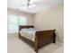 Bedroom featuring wood bed frame, carpeted floors, and window for natural light at 3053 Ramsey Pl, Marietta, GA 30062