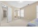 Neutral bedroom featuring carpet, closet, natural light, and door to another room at 3053 Ramsey Pl, Marietta, GA 30062