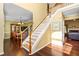 Bright foyer featuring hardwood floors, a staircase with white railings, and views into the dining and living rooms at 3053 Ramsey Pl, Marietta, GA 30062