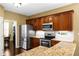 Modern kitchen featuring stainless steel appliances, granite countertops, and a view into the dining area at 3053 Ramsey Pl, Marietta, GA 30062