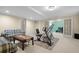 Spacious living room area with work-out equipment, carpeted floors, and French doors at 3053 Ramsey Pl, Marietta, GA 30062