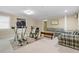 Carpeted living room with natural light, exercise equipment, and comfortable furniture at 3053 Ramsey Pl, Marietta, GA 30062