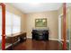 Cozy office space with dark hardwood floors, a large desk, and a piano, perfect for a home workspace at 3053 Ramsey Pl, Marietta, GA 30062