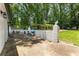 Brick-wall enclosed patio with a grill, potted plants, and decorative statuary at 321 Crabtree Court, Marietta, GA 30068