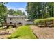 Expansive backyard featuring a deck, patio, lush lawn, and garden at 321 Crabtree Court, Marietta, GA 30068