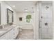 Spa-like bathroom featuring double sinks, marble countertops, and a modern glass-enclosed shower at 321 Crabtree Court, Marietta, GA 30068