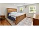 Well-lit bedroom with hardwood floors, a comfortable bed, and large windows at 321 Crabtree Court, Marietta, GA 30068