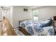Bright bedroom features wood floors, a cozy bed with patterned bedding, and natural light from a window at 321 Crabtree Court, Marietta, GA 30068