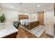 Spacious bedroom with wood floors, a desk area, and a sliding barn door leading to the bathroom at 321 Crabtree Court, Marietta, GA 30068