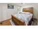 Cozy bedroom featuring wood floors, a plush bed with patterned linens, and natural light from a window at 321 Crabtree Court, Marietta, GA 30068