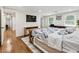 Bright bedroom with hardwood floors, a TV, large windows and a bed with a blue and white patterned comforter at 321 Crabtree Court, Marietta, GA 30068