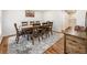 Bright dining room with hardwood floors, rug, wainscoting, and a wooden table with seating for eight at 321 Crabtree Court, Marietta, GA 30068