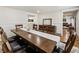 Open dining room features a hardwood floor, a long table with chairs, and views of kitchen and living room at 321 Crabtree Court, Marietta, GA 30068