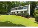 Two-story home with an attached garage, manicured lawn, and lush greenery at 321 Crabtree Court, Marietta, GA 30068