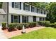 Traditional two-story home with a well-maintained lawn, mature shrubs, and a brick pathway to the front door at 321 Crabtree Court, Marietta, GA 30068