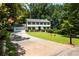 Charming two-story home boasts a manicured lawn and a long driveway leading to an attached garage at 321 Crabtree Court, Marietta, GA 30068
