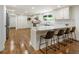 Bright, open kitchen with counter seating, white cabinetry, stainless appliances, and hardwood floors at 321 Crabtree Court, Marietta, GA 30068