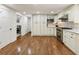 Bright kitchen with white cabinetry, stainless appliances, and hardwood floors at 321 Crabtree Court, Marietta, GA 30068
