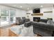 Open living area with fireplace, hardwood floors, slider doors to patio and modern decor at 321 Crabtree Court, Marietta, GA 30068