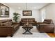 Cozy living room with large leather sofas, hardwood floors and modern decor at 321 Crabtree Court, Marietta, GA 30068