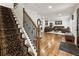 Staircase leads to a living room featuring hardwood floors, and a leather furniture set with center table at 321 Crabtree Court, Marietta, GA 30068