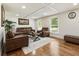 Bright living room featuring hardwood floors, modern lighting and large leather seating at 321 Crabtree Court, Marietta, GA 30068