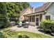 Well-maintained backyard featuring a brick patio and outdoor furniture next to a screened-in porch for relaxation and entertainment at 35 Westfair Ct, Atlanta, GA 30328