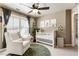 Cozy bedroom with a crib, chair, and shelves, enhanced by natural light streaming through the window at 35 Westfair Ct, Atlanta, GA 30328