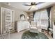 Bright Bedroom with white furniture, round rug, ceiling fan, and a window providing natural light at 35 Westfair Ct, Atlanta, GA 30328
